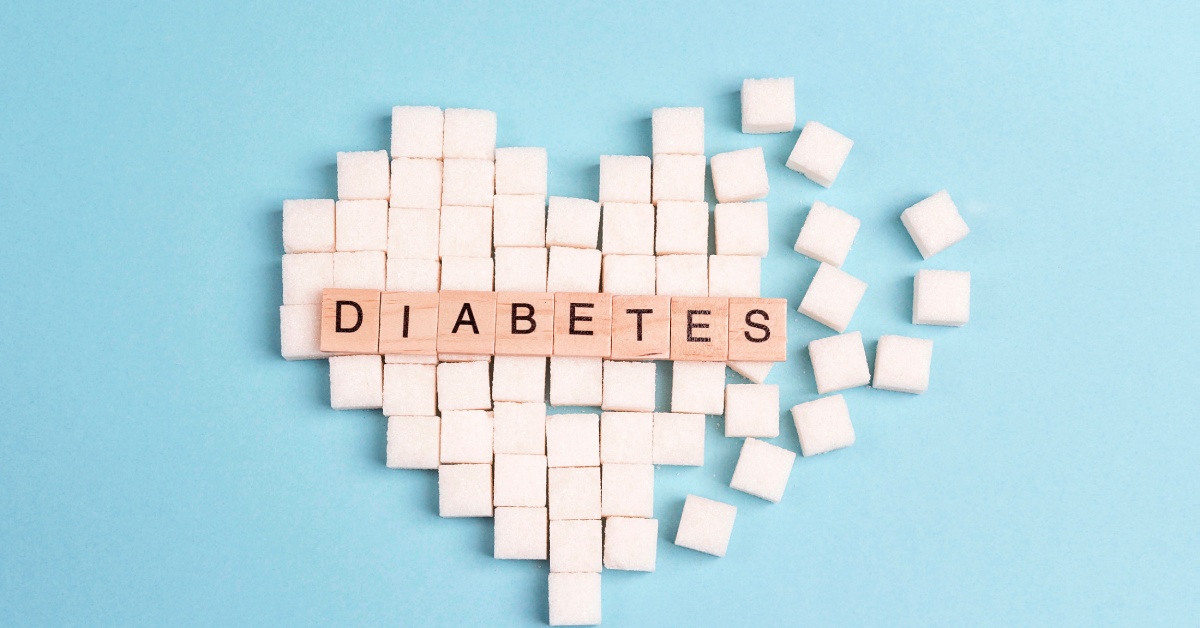 A broken heart consisting of sugar cubes features additional wooden blocks on top. The blocks spell the word "Diabetes."